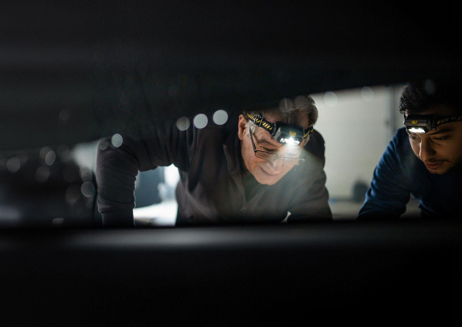 Ledlenser headlamp two men fixing car
